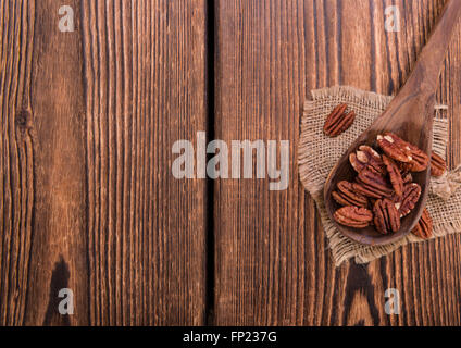 Rustikaler Holztisch mit einigen Pecan-Nüssen (Tiefenschärfe) Stockfoto