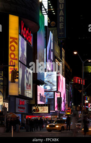 Blick auf Times Square in New York in der Nacht, die hellen Lichtern dominieren das Bild. Stockfoto