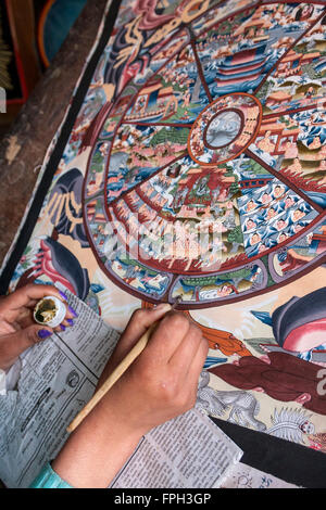 Nepal, Patan.  Junge Frau ein Thangka Malerei ein tibetisch-buddhistische Gemälde. Stockfoto