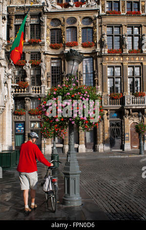 Ein Radfahrer und Hintergrund Gebäude Louve, Sac und Brouette. Grand-Place, Brüssel, Belgien. Louve, Sac und Brouette sind eine gr Stockfoto