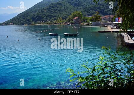 Berge und Meer aufeinander treffen; idyllische Bucht mit klares Wasser und ein ruhiger Strand im Dorf Morin, die Bucht von Kotor, Montenegro Stockfoto