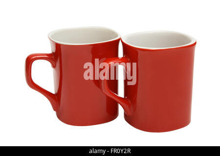 Zwei rote Tassen auf weißem Hintergrund Stockfoto