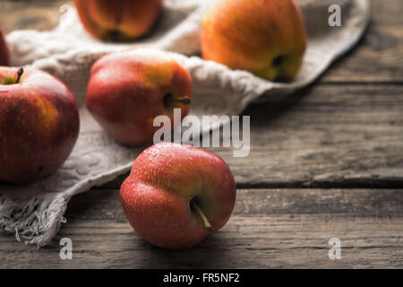 Rote Äpfel und Handtuch auf die alten Bretter horizontal Stockfoto