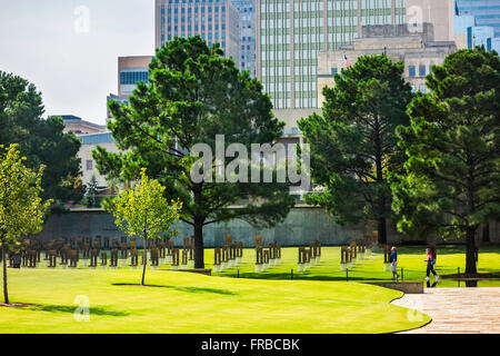 Das Gelände von der Oklahoma City bombing Denkmal, zeigt die Bereich der Stühle und Stadt Gebäuden. Oklahoma, USA. Stockfoto