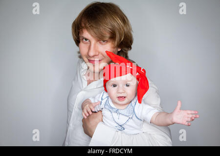 Vater hält ein Kind von sieben Monaten Stockfoto