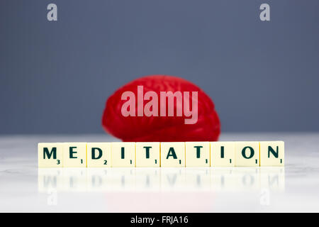 Rote Gehirn mit Meditation Zeichen auf dunklem Hintergrund Stockfoto
