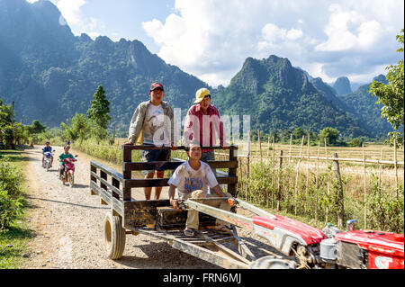 Asien. Süd-Ost-Asien. Laos. Provinz von Vang Vieng. Bauerndorf. Bauer auf einem Traktor aus den Bereichen zurück. Stockfoto