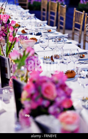 Festlichen Tisch mit Blumensträuße und Vorspeisen in einem restaurant Stockfoto