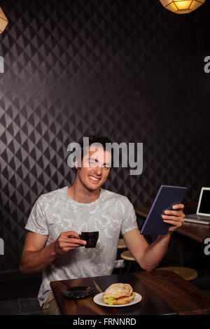 Hipster-Mann mit Tablett mit Kaffee und sandwich Stockfoto