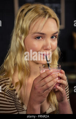 Frau trinkt ein milchshake Stockfoto