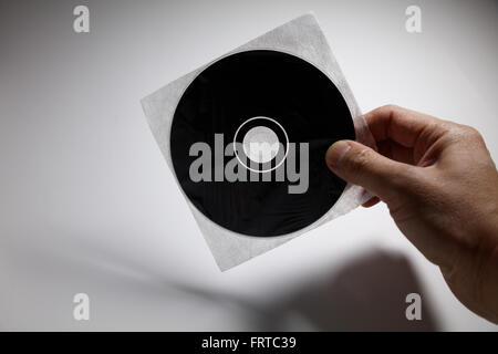 Hand mit einer CD, DVD Laufwerk, Technologie-Konzept. Stockfoto