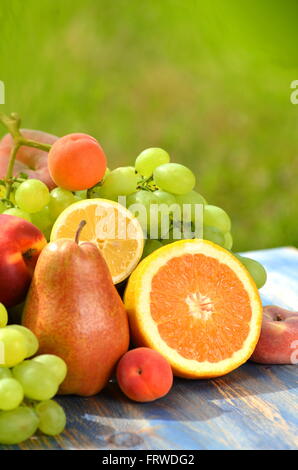 Fruchtvielfalt auf Tisch im Garten Stockfoto