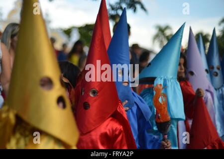 Gekleidet als mit Kapuze Farricocos Kinder nehmen an einer religiösen Prozession, bekannt als die Prozession Fackeln in der Karwoche 23. März 2016 in Goias, Brasilien. Die Prozession symbolisiert die Suche und die Verhaftung von Christus und die Farricocos stellen die römischen Soldaten. Stockfoto