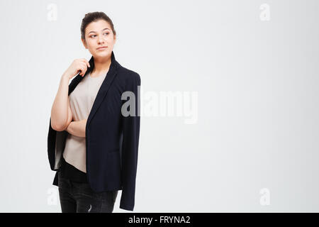 Porträt von Ernst schöne junge Frau in Jacke stehend auf weißem Hintergrund Stockfoto