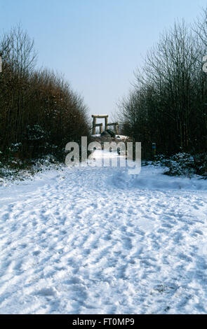 Eine riesige Holzstuhl Skulptur des Künstlers Magdalena Jetelo in einer verschneiten Landschaft im Winter im Wald des Dekans, Gloucestershire Stockfoto