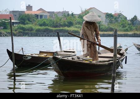 Vietnamesin Vorbereitung ein Boot für touristische Ausflüge am Thu Bon Fluss in Hoi an, Vietnam. Stockfoto