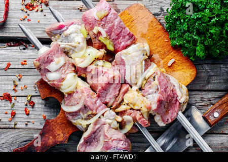 Fleisch mit Gewürzen und Marinade mit Kiwi am Spieß für Kebabs mit Gewinde Stockfoto