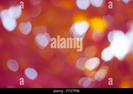 Bokeh Herz Form hellen Hintergrund Pink und Orange gefärbt Stockfoto