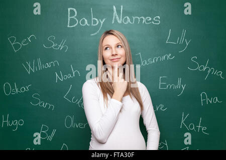 Schwangere Frau versucht, einen Namen für ihr Baby wählen Stockfoto