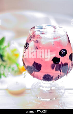 Cocktail in ein Glas mit Beeren und Wasser spritzt Stockfoto