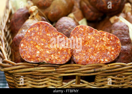 Hausgemachte ungarische Salami halbieren in Korb zum Verkauf Stockfoto