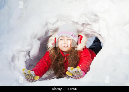 Glückliches Mädchen, die Spaß im Schnee-tunnel Stockfoto