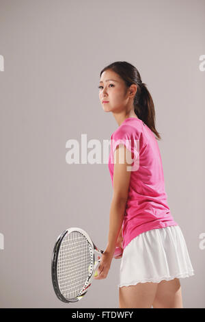 Junge japanische Tennisspielerin in Aktion Stockfoto