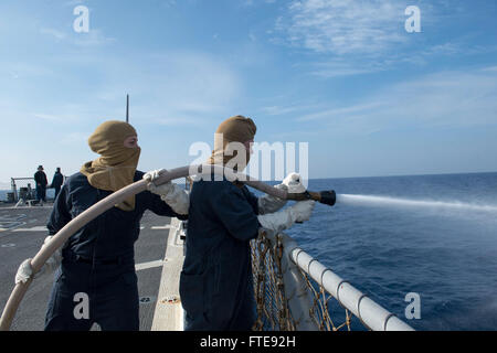 Mittelmeer (7. Januar 2014) - Maschinen Mechaniker 2. Klasse Robert Briggs, rechts, und Rumpf Wartung Techniker Seemann Kirsten Jones Mann ein Ablaufschlauch während eines Schadensbegrenzung Team Trainings an Bord der Arleigh-Burke-Klasse geführte Flugkörper Zerstörer USS Stout (DDG-55).  Stout, Gridley in Norfolk, Virginia, ist auf eine geplante Bereitstellung unterstützen maritimer Sicherheitsoperationen und Sicherheitsbemühungen Zusammenarbeit Theater in den USA 6. Flotte Einsatzgebiet. (Foto: U.S. Navy Mass Communication Specialist 2. Klasse Amanda R. Gray/freigegeben) Stockfoto