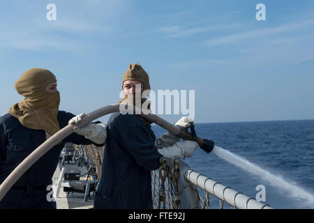 Mittelmeer (7. Januar 2014) - Maschinen Mechaniker 2. Klasse Robert Briggs, rechts, und Rumpf Wartung Techniker Seemann Kirsten Jones Mann ein Ablaufschlauch während eines Schadensbegrenzung Team Trainings an Bord der Arleigh-Burke-Klasse geführte Flugkörper Zerstörer USS Stout (DDG-55).  Stout, Gridley in Norfolk, Virginia, ist auf eine geplante Bereitstellung unterstützen maritimer Sicherheitsoperationen und Sicherheitsbemühungen Zusammenarbeit Theater in den USA 6. Flotte Einsatzgebiet. (Foto: U.S. Navy Mass Communication Specialist 2. Klasse Amanda R. Gray/freigegeben) Stockfoto