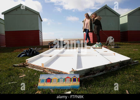 Brighton, UK. 28. März 2016. Hundebesitzer betrachten beschädigte Strandhütten in Hove, nachdem Wind und Regen durch Sturm Katie brachte die Küste in Brighton, East Sussex, UK Montag, 28. März 2016 zerschlagen. BBC berichten "Sturm Katie Böen von bis zu 105 km/h Misshandlung von England und Wales, mit mehreren Flügen von Flughäfen umgeleitet gesehen hat und große Brücken geschlossen". Bildnachweis: Luke MacGregor/Alamy Live-Nachrichten Stockfoto