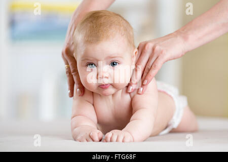 Mutter oder Therapeut macht massage, um ihr Baby zu Hause. Gesundheit und Medizin-Konzept. Stockfoto