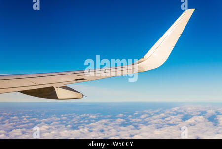 Flugzeugflügel fliegen über den Wolken Stockfoto