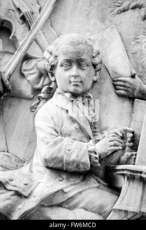 Wolfgang Mozart als Kind spielt. Schnitzerei. Szene auf Mozart-Denkmal in den Burggarten von der Ringstraße. Laaser Marmor Stockfoto