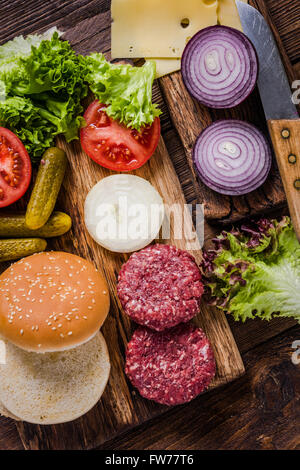 Hausgemachte Burger Zutaten auf rustikalen Holztisch Stockfoto