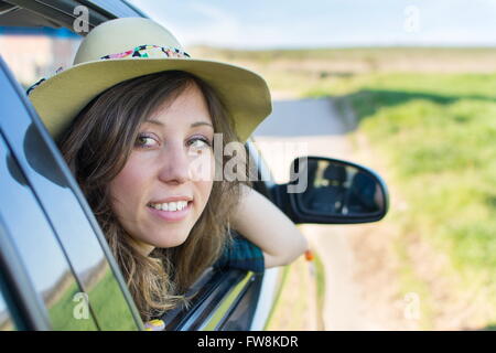 Frau auf der Suche durch Autofenster auf einem Roadtrip Stockfoto