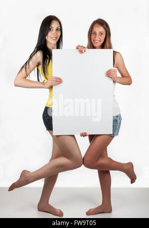 Geschäftliche lächelnde Mädchen hält eine weiße leere Karte auf weißem Hintergrund Stockfoto