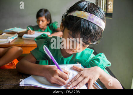 Ein kleines Mädchen schreiben Ngo ländlichen Grundschule Klassenzimmer unterstützt bei System Center, tangail, Dhaka © jahangir Alam onuchcha/alamy Stockfoto