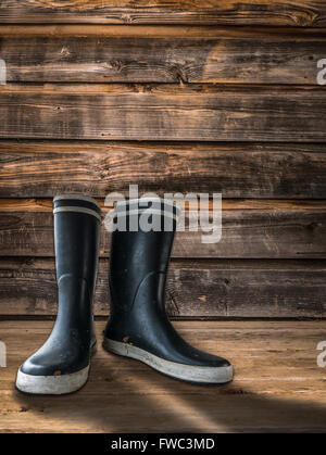 Gummistiefel auf der Veranda eines Bauernhauses Stockfoto