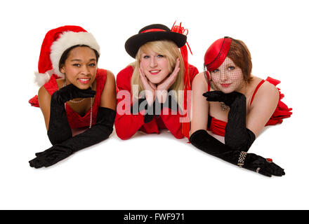 Drei junge Damen posieren in ihre Christmas Party Kleider und Hüte Stockfoto