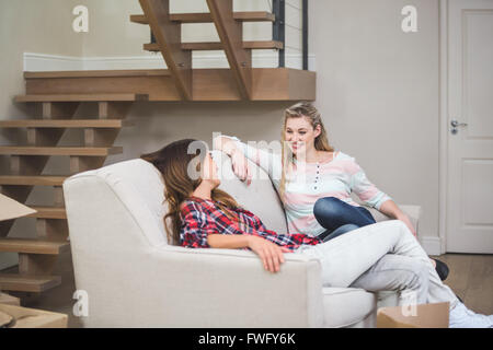 Zwei schöne Frauen, die miteinander reden, während Sie gemütlich auf dem sofa Stockfoto