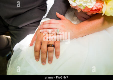 Eine Braut und Bräutigam haben ihre Hände am Tag ihrer Hochzeit zu zeigen, ihre Eheringe fotografiert. Stockfoto