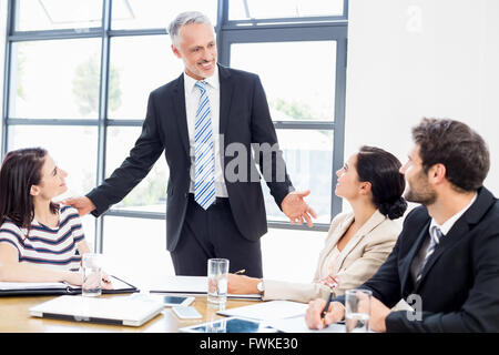 Ein Geschäftsmann ist im Gespräch mit seinen Kollegen und alle Lächeln Stockfoto