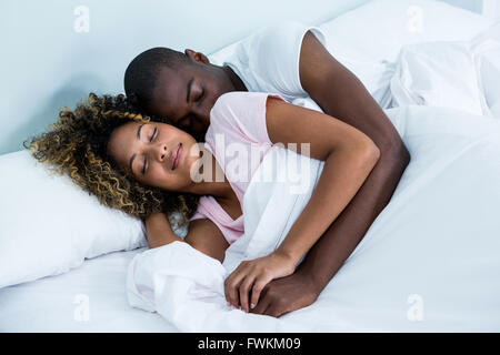 Junges Paar miteinander schliefen auf Bett Stockfoto