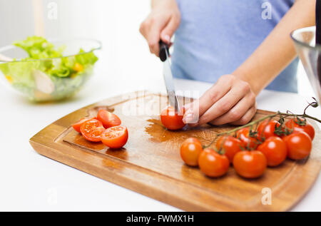 Nahaufnahme von Frau hacken Tomaten mit Messer Stockfoto