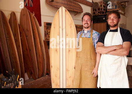 Porträt der Zimmerleute machen maßgeschneiderte Surfbretter In Werkstatt Stockfoto