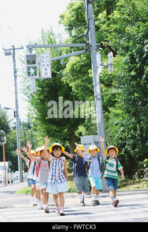 Japanische Schule Kinder, die Straße überqueren Stockfoto