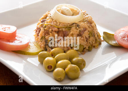 Kubanische Küche traditionelle kreolische gelbem Reis garniert mit Oliven, Zwiebeln, Tomaten und Pickels. Stockfoto