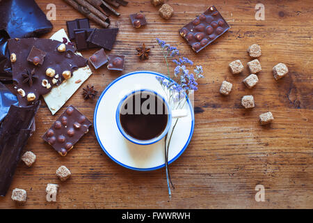 Tasse Kaffee und verschiedene Arten von handgemachte Schokolade, Top Aussicht auf hölzernen Hintergrund im café Stockfoto