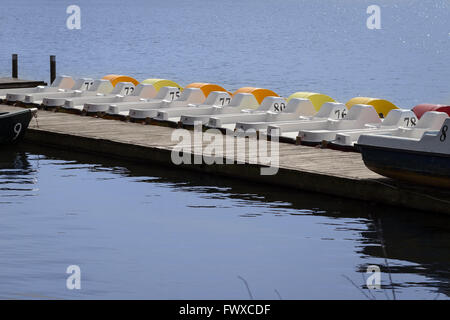 Linie von Tretbooten auf einem Pier - Reihe von Booten Stockfoto