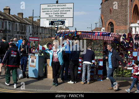 Eine Frau posiert für ein Foto mit ihr Halstuch empor an der Ecke der Green Street und Castle Street in der Nähe der Boleyn Ground, bevor West Ham United Crystal Palace in einem Barclays Premier League Match gehostet. Die Boleyn Ground im Upton Park war der Club Heimstadion von 1904 bis zum Ende der Saison 2015 / 16 in das Olympiastadion für die Spiele 2012 in London, in der Nähe Stratford gebaut zog. Das Spiel endete mit einem 2: 2 Unentschieden, beobachtet von einem in der Nähe von ausverkauftem von 34.857. Stockfoto